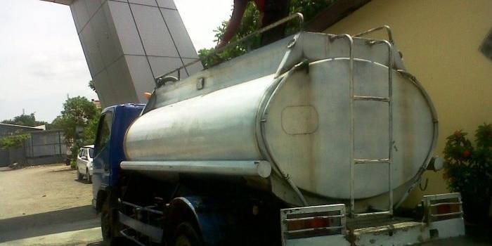 Salah satu petugas menunjukan barang bukti BBM ilegal yang diduga berjenis solar sebanyak 5.000 liter di Mapolres Bojonegoro. Foto: Eky Nurhadi/BangsaOnline.com
