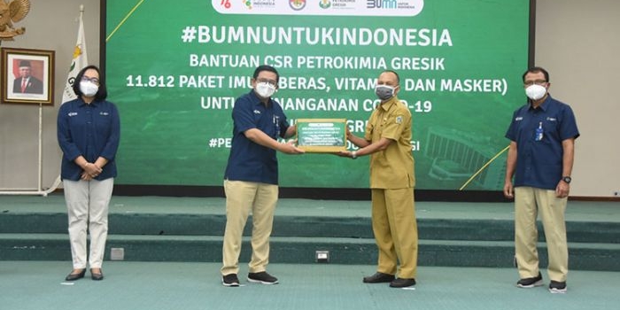 Direktur Utama Petrokimia Gresik Dwi Satriyo Annurogo menyerahkan bantuan paket imun secara simbolis kepada perwakilan lurah. (foto: SYUHUD/ BANGSAONLINE)