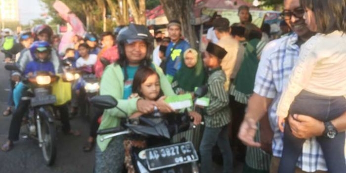 Kapolres Kediri Kota AKBP Anthon Hariyadi bersama anak yatim piatu saat bagi takjil didepan terminal Tamanan Kota Kediri. foto: ARIF KURNIAWAN/ BANGSAONLINE