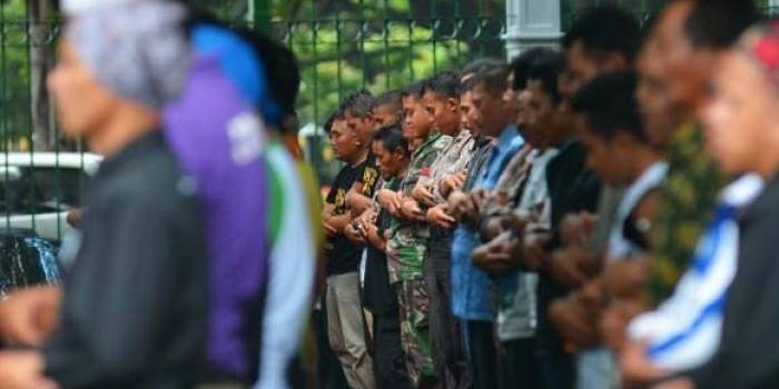TAK LUPA: Meski dalam suasana demo, para guru tampak khusyuk melakukan salat jumlah di Lapangan Monas. Tampak aparat keamanan juga khidmat salam satu shaf (barisan). foto: merdeka.com
