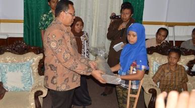 Bupati Situbondo menyerahkan bantuan kaki palsu secara simbolis kepada salah seorang penyandang difabel. (Hadi Prayitno/BANGSAONLINE)