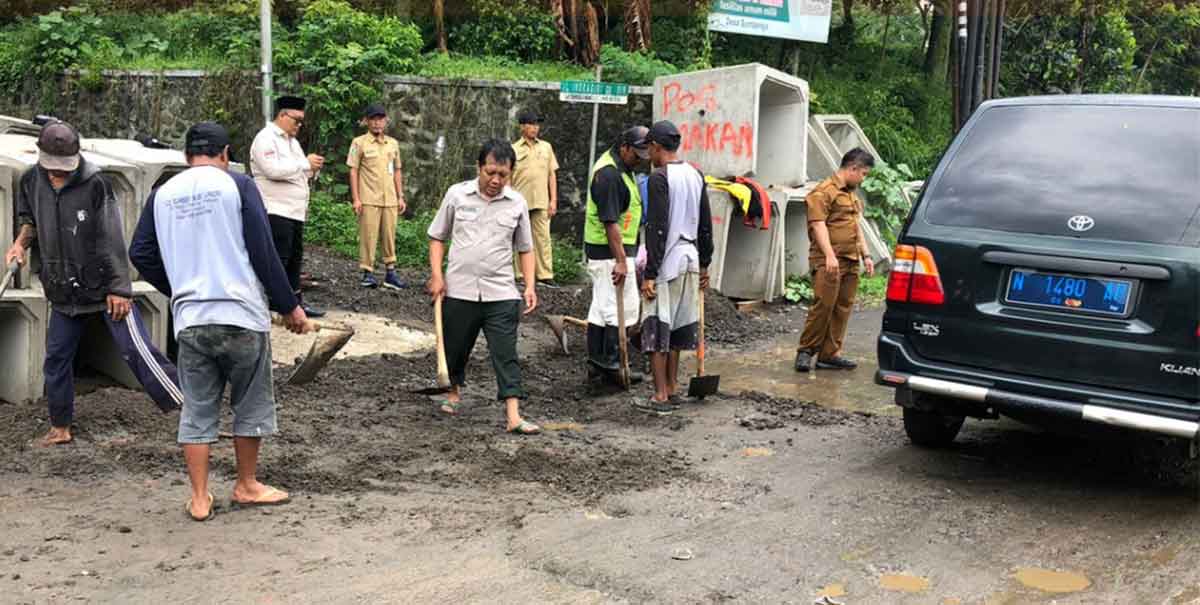 Petugas dari BPBD Kota Batu saat meninjau dampak longsor dan banjir.
