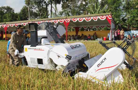 Bupati Tulungagung Syahri Mulyo SE MSi saat mengoperasikan mesin panen. (foto: ferry/BANGSAONLINE)