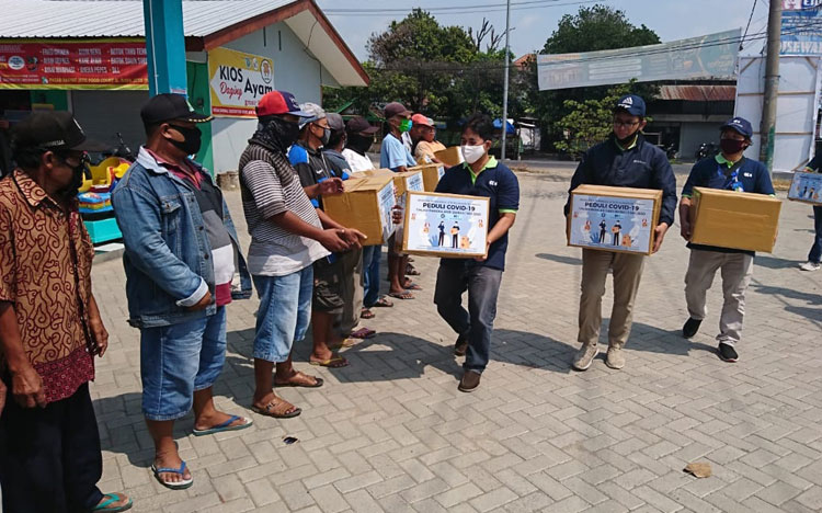 Aksi kepedulian karyawan PT Kitoshindo yang membagikan 60 paket sembako kepada Supeltas. (foto: YUDI EP/ BANGSAONLINE)