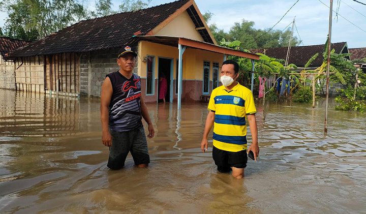 Camat Balongpanggang M. Yusuf Ansyori (kanan) saat meninjau desa yang terendam banjir luapan Kali Lamong. Foto: SYUHUD/ BANGSAONLINE.com