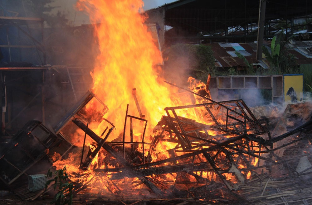 Kobaran api saat melalap pagupon di lahan kosong yang berlokasi di Jalan Karang Asem, Ploso, Surabaya.